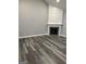 View of a cozy living room with hardwood floors, fireplace and neutral wall paint at 2200 Hickory Station Cir, Snellville, GA 30078