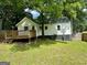 View of the home's back exterior with a small deck perfect for outdoor relaxation at 1681 Stanton Sw Rd, Atlanta, GA 30311