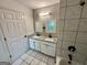 Bathroom featuring a tiled wall, shower and bath, and a dual-sink granite vanity at 1681 Stanton Sw Rd, Atlanta, GA 30311