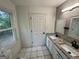 Bright bathroom featuring double sink vanity with granite countertop and white cabinets at 1681 Stanton Sw Rd, Atlanta, GA 30311