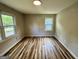 Bright bedroom featuring durable wood flooring, large windows, and neutral wall paint at 1681 Stanton Sw Rd, Atlanta, GA 30311