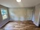 Spacious bedroom with modern wood flooring, a window, and a neutral color palette at 1681 Stanton Sw Rd, Atlanta, GA 30311