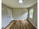 A cozy bedroom that features updated flooring, a window, and neutral colored walls at 1681 Stanton Sw Rd, Atlanta, GA 30311