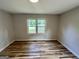 Empty bedroom with two windows and dark brown wood-look floors at 1681 Stanton Sw Rd, Atlanta, GA 30311