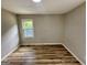 Bedroom featuring wood flooring, a window providing natural light, and neutral-painted walls at 1681 Stanton Sw Rd, Atlanta, GA 30311