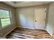 Cozy bedroom featuring wood floors, natural light, and neutral wall color at 1681 Stanton Sw Rd, Atlanta, GA 30311