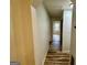 A well lit hallway with light walls and dark brown wood floors at 1681 Stanton Sw Rd, Atlanta, GA 30311