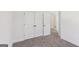 Bedroom featuring neutral carpeting, white walls, a closet, and an ensuite bathroom at 3278 Greenhill Dr, Villa Rica, GA 30180