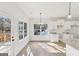Eat-in kitchen featuring white cabinets, granite countertops, tile backsplash, and access to a wood deck at 3278 Greenhill Dr, Villa Rica, GA 30180