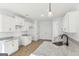 Kitchen features white cabinets, granite countertops, stainless steel sink, and modern fixtures at 3278 Greenhill Dr, Villa Rica, GA 30180