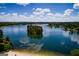 Stunning aerial view of lake with island, dock, and blue sky with clouds at 2279 Lakeview Pkwy, Villa Rica, GA 30180