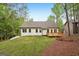 The level backyard has a small deck and lush, green trees at 2279 Lakeview Pkwy, Villa Rica, GA 30180