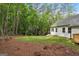 Expansive backyard with lush green grass and tree-lined perimeter. Includes partially wooded lot and a modern home exterior at 2279 Lakeview Pkwy, Villa Rica, GA 30180