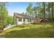 Backyard of the home has a gradual slope and is surrounded by trees at 2279 Lakeview Pkwy, Villa Rica, GA 30180