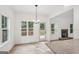 Sunlit dining area with hardwood floors and views of the backyard and stone fireplace at 2279 Lakeview Pkwy, Villa Rica, GA 30180