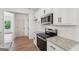 Bright kitchen features white cabinets, granite countertops, stainless steel appliances, and natural light at 2279 Lakeview Pkwy, Villa Rica, GA 30180