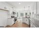 Bright kitchen features white cabinets, granite countertops, stainless steel appliances, and natural light at 2279 Lakeview Pkwy, Villa Rica, GA 30180