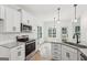 Bright kitchen features white cabinets, granite countertops, stainless steel appliances, and natural light at 2279 Lakeview Pkwy, Villa Rica, GA 30180