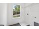 Bright laundry room with window, white walls, and gray flooring with included washer connections at 2279 Lakeview Pkwy, Villa Rica, GA 30180