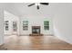 Bright, open living room featuring a stone fireplace, ceiling fan, and ample natural light at 2279 Lakeview Pkwy, Villa Rica, GA 30180