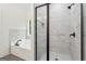 Tiled shower with glass enclosure and rainfall showerhead in a modern new bathroom at 2279 Lakeview Pkwy, Villa Rica, GA 30180