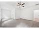 Spacious main bedroom with tray ceilings, ceiling fan, carpet, and bright white walls at 2279 Lakeview Pkwy, Villa Rica, GA 30180