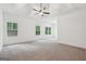 Bright main bedroom with tray ceiling, ceiling fan, large windows and neutral carpet at 2279 Lakeview Pkwy, Villa Rica, GA 30180