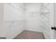 Walk-in closet featuring wire shelving, carpet flooring, and ample storage space at 2279 Lakeview Pkwy, Villa Rica, GA 30180
