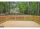 Elevated wooden deck with wooden railing, surrounded by beautiful lush trees and greenery, offering an outdoor entertaining space at 2279 Lakeview Pkwy, Villa Rica, GA 30180