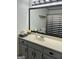 Bathroom with grey cabinets, modern fixtures, and a large mirror above the sink at 5526 Stoneleigh Court, Stone Mountain, GA 30088