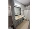 Bathroom featuring a vanity sink, toilet, and shower, as well as neutral tiled flooring at 5526 Stoneleigh Court, Stone Mountain, GA 30088