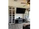 Bedroom featuring built-in bookshelves, modern entertainment center, and a ceiling fan at 5526 Stoneleigh Court, Stone Mountain, GA 30088