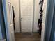 Walk-in closet with clothing racks, storage shelves and a door leading to another area at 5526 Stoneleigh Court, Stone Mountain, GA 30088
