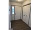 Bright entryway featuring modern flooring, a paneled front door, and a closet with bi-fold doors at 5526 Stoneleigh Court, Stone Mountain, GA 30088