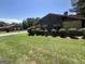 Well-maintained yard with healthy green grass and manicured shrubbery surrounding the building at 5526 Stoneleigh Court, Stone Mountain, GA 30088