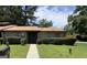Charming brick home featuring a well-manicured lawn, mature trees, and welcoming front entrance at 5526 Stoneleigh Court, Stone Mountain, GA 30088