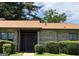 Well-maintained brick home with a brown roof, lush greenery, and inviting front entrance at 5526 Stoneleigh Court, Stone Mountain, GA 30088