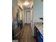 Hallway connecting stainless steel refrigerator, blue cabinets, washer and dryer and multiple rooms at 5526 Stoneleigh Court, Stone Mountain, GA 30088