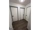 Hallway with wood floor and access to rooms with white doors and black handles at 5526 Stoneleigh Court, Stone Mountain, GA 30088