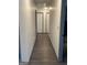 Hallway featuring neutral paint, wood flooring, and white doors at 5526 Stoneleigh Court, Stone Mountain, GA 30088