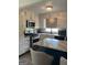 Well-lit kitchen features white cabinetry, stainless steel appliances, and an island with a marble countertop at 5526 Stoneleigh Court, Stone Mountain, GA 30088