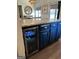 Kitchen island with a built-in beverage cooler, marble countertop, and blue cabinetry at 5526 Stoneleigh Court, Stone Mountain, GA 30088