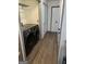 Convenient laundry room featuring new washer and dryer units and modern wood flooring at 5526 Stoneleigh Court, Stone Mountain, GA 30088