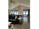 Open concept living room featuring hardwood floors, designer lighting, and a seamless transition to the dining space at 5526 Stoneleigh Court, Stone Mountain, GA 30088