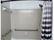 Shower featuring tile surround, safety grab bars, and black and white shower curtain at 5526 Stoneleigh Court, Stone Mountain, GA 30088