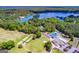 Aerial view featuring golf course, tennis courts, pool, waterfront, and lush greenery at 3279 Greenhill Dr, Villa Rica, GA 30180