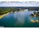 Breathtaking aerial view showcasing a tranquil lake surrounded by lush green forests and waterfront homes at 3279 Greenhill Dr, Villa Rica, GA 30180
