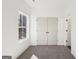 Small bedroom with natural light, neutral carpeting, and a spacious closet at 3279 Greenhill Dr, Villa Rica, GA 30180