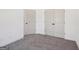 Neutral bedroom features plush gray carpeting and two doors with black hardware at 3279 Greenhill Dr, Villa Rica, GA 30180