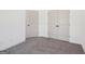 Neutral bedroom features plush gray carpeting and two doors with black hardware at 3279 Greenhill Dr, Villa Rica, GA 30180